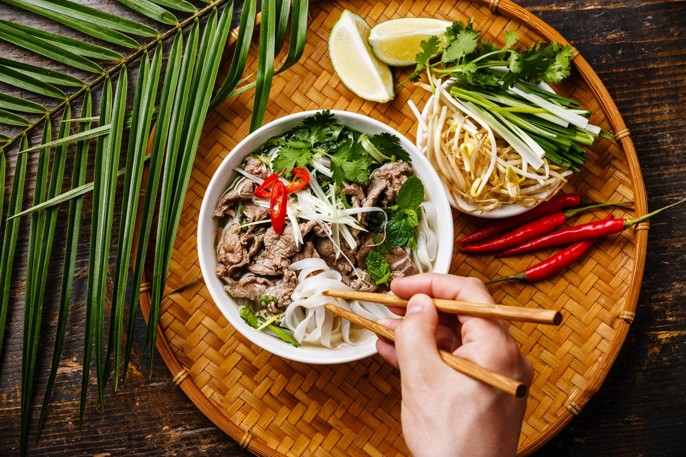 Bowl of Phở Hà Nội with herbs and sliced beef